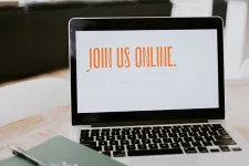 Picture of a computer with the text "join us online" on the screen