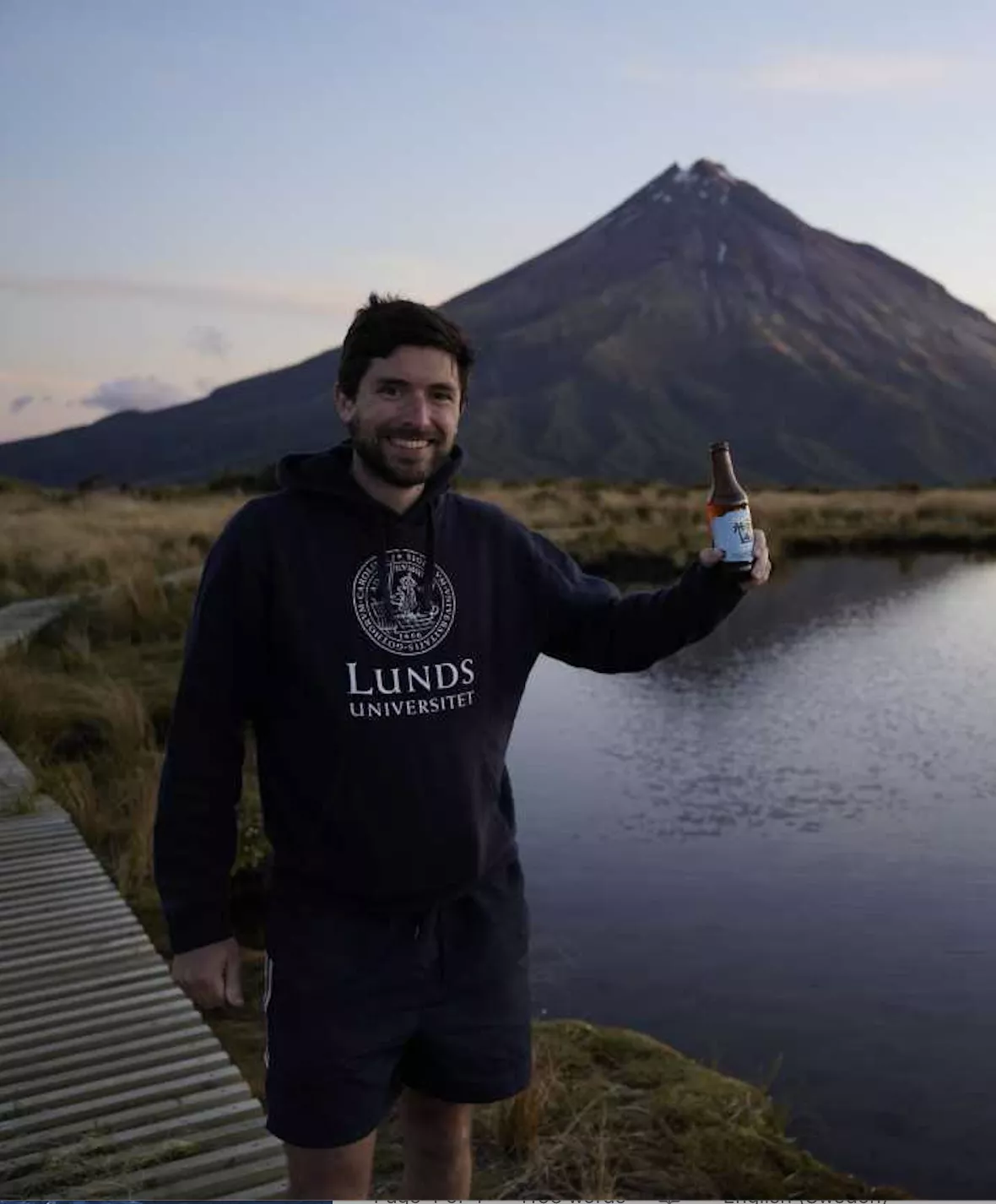 Student standing in front of Mount Taranaki in New Zealand.